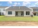 Rear view of a house showcasing a patio and yard at 326 Blue Oak Dr, Moncks Corner, SC 29461