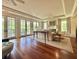 Bright living room featuring hardwood floors, French doors opening to a balcony, and ample natural light at 5 Middle Atlantic Wharf # 3A, Charleston, SC 29401