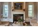 Elegant living room features a fireplace, built-in shelving, and large windows at 5 Middle Atlantic Wharf # 3A, Charleston, SC 29401