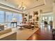 Sun-drenched living room with hardwood floors, comfortable seating, and large windows at 5 Middle Atlantic Wharf # 3A, Charleston, SC 29401