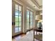 French doors open to a private balcony overlooking lush greenery at 5 Middle Atlantic Wharf # 3A, Charleston, SC 29401