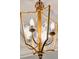 Ornate gold chandelier with etched glass panels adds a touch of elegance at 5 Middle Atlantic Wharf # 3A, Charleston, SC 29401
