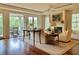 Relaxing living room with hardwood floors and access to a private balcony overlooking lush greenery at 5 Middle Atlantic Wharf # 3A, Charleston, SC 29401