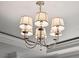 Modern chandelier with five white shades adds a touch of elegance at 5 Middle Atlantic Wharf # 3A, Charleston, SC 29401