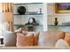 Living room with a neutral color palette, decorative pillows, and built-in shelving at 5 Middle Atlantic Wharf # 3A, Charleston, SC 29401