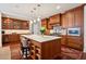 Spacious kitchen boasts an island, wood cabinetry, and marble countertops at 5 Middle Atlantic Wharf # 3A, Charleston, SC 29401