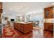 Open kitchen with island, hardwood floors, and adjacent dining area at 5 Middle Atlantic Wharf # 3A, Charleston, SC 29401