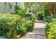 Brick pathway through a lush green garden at 5 Middle Atlantic Wharf # 3A, Charleston, SC 29401