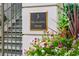 Building entrance with a plaque and flowers at 5 Middle Atlantic Wharf # 3A, Charleston, SC 29401
