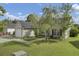 Tan house with black shutters, attached garage, and landscaped lawn at 203 Delafield Dr, Summerville, SC 29483