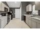 Modern kitchen with gray cabinets, marble countertops, and stainless steel appliances at 203 Delafield Dr, Summerville, SC 29483