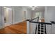 Upstairs hallway with hardwood floors and access to bedrooms and laundry at 205 Valley St, Walterboro, SC 29488
