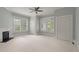 Spacious bedroom with hardwood floors, fireplace, ceiling fan, and large windows at 205 Valley St, Walterboro, SC 29488