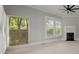 Bright bedroom with hardwood floors, fireplace, and large windows with window blinds at 205 Valley St, Walterboro, SC 29488