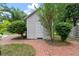 White shed with brick pathway, surrounded by greenery at 205 Valley St, Walterboro, SC 29488