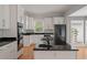 Spacious kitchen with granite countertops, white cabinets, and stainless steel appliances at 205 Valley St, Walterboro, SC 29488