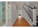 Charming entryway with hardwood floors, glass-front cabinet, and staircase at 205 Valley St, Walterboro, SC 29488