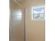 Small shower with a textured glass door and window at 205 Valley St, Walterboro, SC 29488