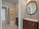 Elegant bathroom with a vanity, an oval mirror, and a shower with tiled walls at 205 Valley St, Walterboro, SC 29488