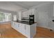Eat-in kitchen with large island, granite countertops, white cabinets, and hardwood floors at 205 Valley St, Walterboro, SC 29488