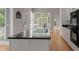 Kitchen island with granite countertop and breakfast bar, hardwood floors, and white cabinets at 205 Valley St, Walterboro, SC 29488