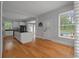 Bright kitchen with hardwood floors, island, white cabinets, and view of backyard pool at 205 Valley St, Walterboro, SC 29488