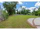 Large backyard with a grassy area, trees, and wooden fence at 205 Valley St, Walterboro, SC 29488