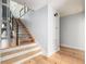 Modern staircase with metal railing and light wood floors at 403 Pelican Flight Dr, Dewees Island, SC 29451
