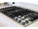 Close-up of a five-burner gas cooktop with sleek stainless steel finish at 403 Pelican Flight Dr, Dewees Island, SC 29451