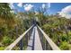 Elevated boardwalk leading to a stunning waterfront home at 403 Pelican Flight Dr, Dewees Island, SC 29451