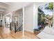 Light-filled hallway with hardwood floors, open staircase at 403 Pelican Flight Dr, Dewees Island, SC 29451