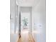 Bright hallway with light wood floors and access to laundry at 403 Pelican Flight Dr, Dewees Island, SC 29451