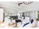 Spacious living room with white sofas, hardwood floors, and high ceilings at 403 Pelican Flight Dr, Dewees Island, SC 29451