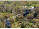 Elevated view of a stunning house with a boardwalk over lush greenery at 403 Pelican Flight Dr, Dewees Island, SC 29451