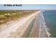 Aerial view of beach shoreline with homes in background at 4426 Sea Forest Dr, Kiawah Island, SC 29455