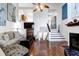 Bright living room features hardwood floors, a fireplace, and access to staircase at 1721 Live Oak Park, Seabrook Island, SC 29455