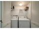 Laundry closet with washer, dryer, and overhead shelving at 2221 Oyster Catcher Ct, Seabrook Island, SC 29455