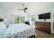 Main bedroom with king-size bed, TV, and access to a balcony at 2221 Oyster Catcher Ct, Seabrook Island, SC 29455