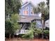 Two-story light blue house with white trim and a deck at 2221 Oyster Catcher Ct, Seabrook Island, SC 29455