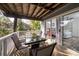 Covered deck with table and chairs, offering views of backyard and bedroom at 2221 Oyster Catcher Ct, Seabrook Island, SC 29455