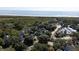 Aerial view of a coastal community with houses near the ocean at 2221 Oyster Catcher Ct, Seabrook Island, SC 29455