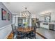 Bright dining area with a round table and chairs, open to the kitchen at 480 Magnolia Rd, Charleston, SC 29407