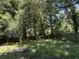 Large backyard with mature trees and a wooden fence at 106 Teddy Ct, Summerville, SC 29485