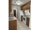 Kitchen with wood cabinets, white appliances, and tile floor at 106 Teddy Ct, Summerville, SC 29485