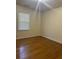 Simple bedroom featuring hardwood floors and a window with blinds at 1219 Oakcrest Dr, Charleston, SC 29412