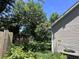 Spacious backyard with mature trees and partial fence at 4504 Winterwood Pl, Ladson, SC 29456