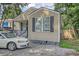 Small beige house with a carport and mature trees in the front yard at 2832 Ranger Dr, North Charleston, SC 29405