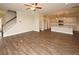 Spacious living room with hardwood floors, kitchen island, and a view of the staircase at 508 Eagleview Dr, Moncks Corner, SC 29461