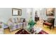 Bright living room with hardwood floors, sofas, and large windows at 1426 Sc-45, McClellanville, SC 29458