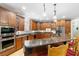 Large kitchen with granite countertops, wood cabinets, and island at 1426 Sc-45, McClellanville, SC 29458